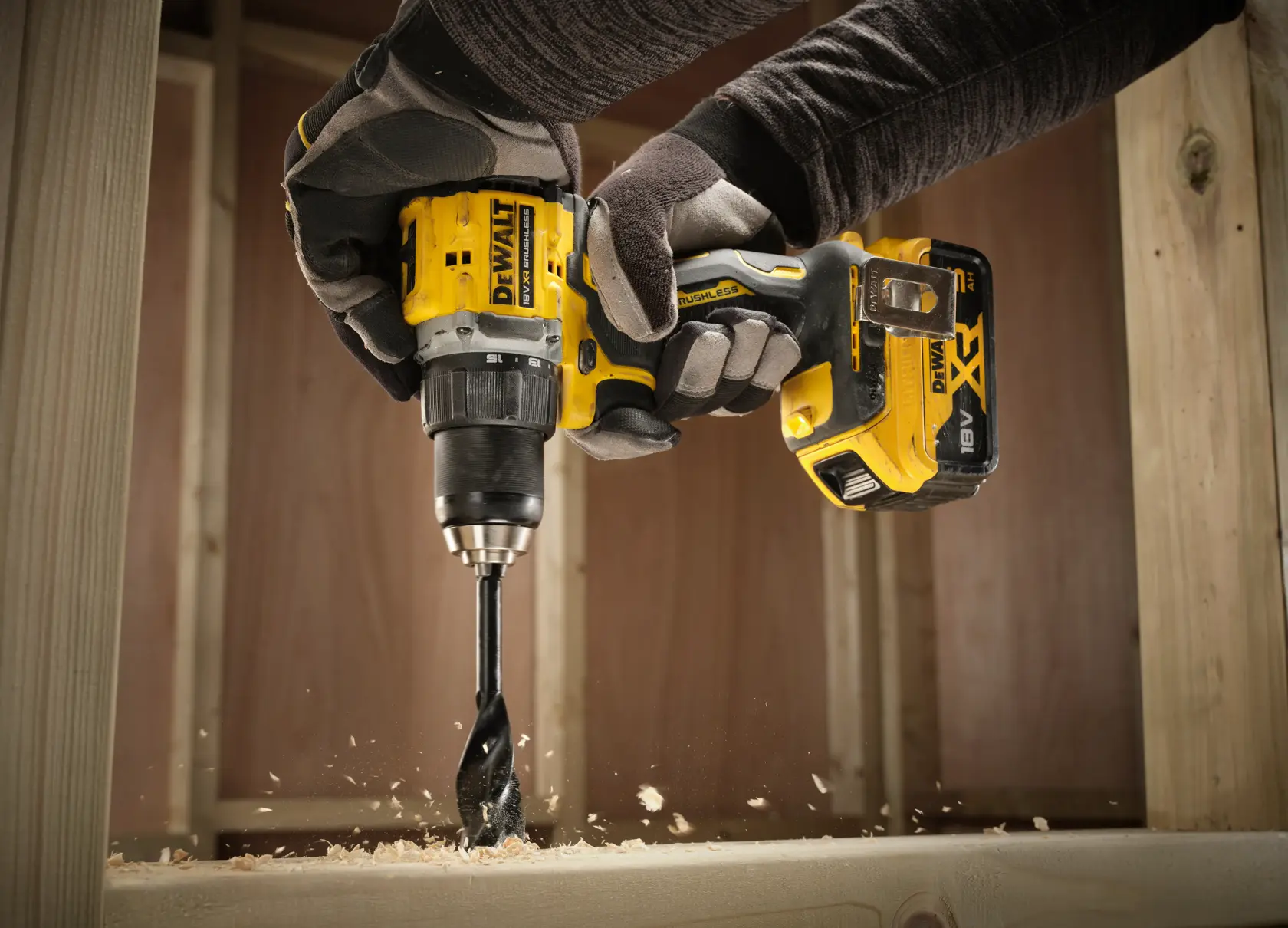 DEWALT drill in use, drilling wood. Models DCD794NT, DCD794NT-XJ shown in action.