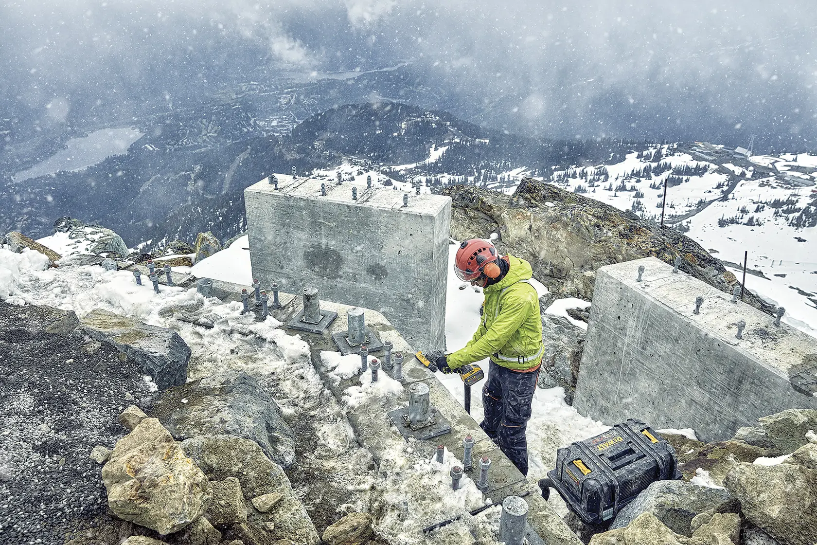 DEWALT DCZ507T2-XE, DCG418N, DCZ503X2-XE used outdoors in snowy mountain construction. Photography product image.