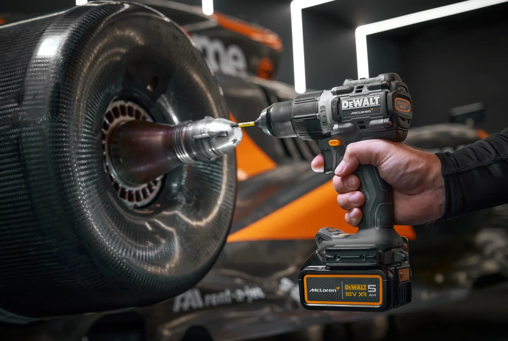 DEWALT DCK200MP2T, DCK200MP2T-XE drill used on car wheel. Photography product close-up.