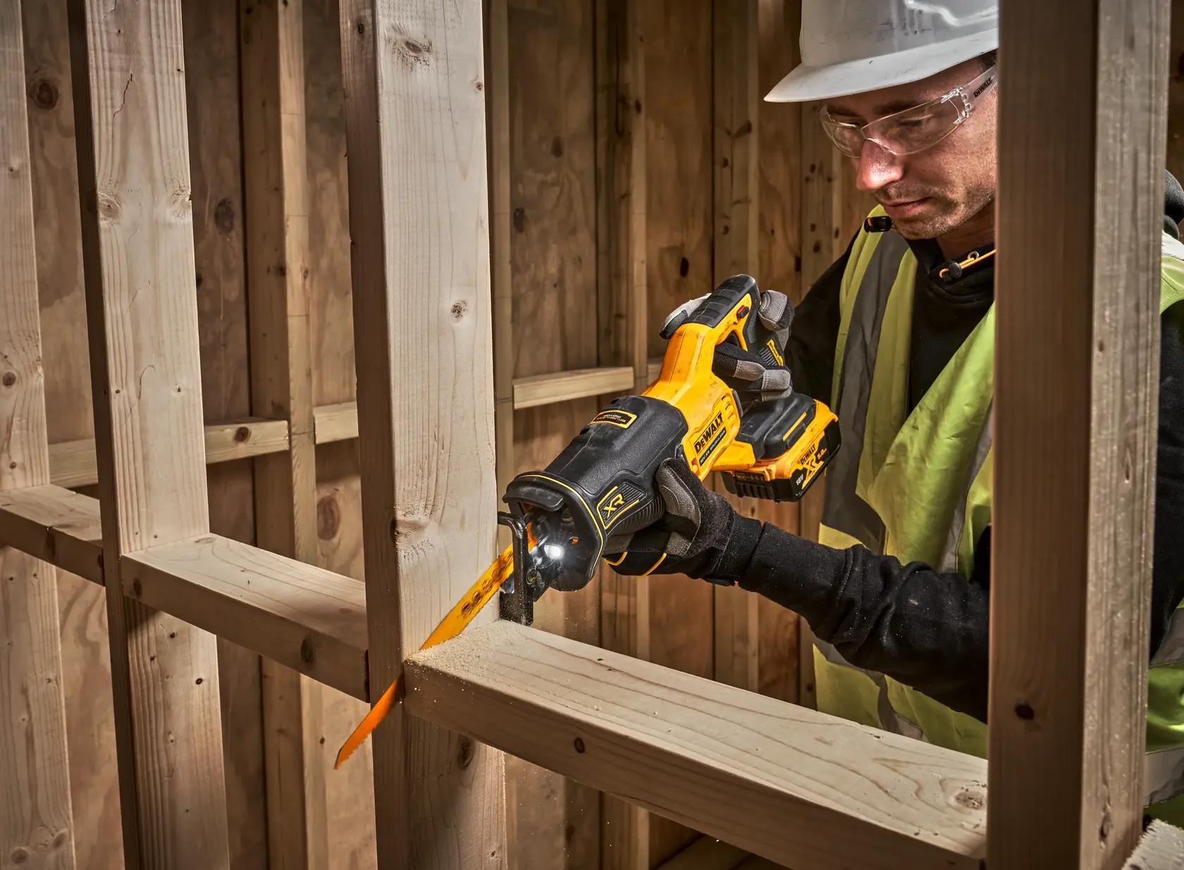 DEWALT DCS382N, DCS382N-XJ saw in use cutting wood at a construction site.