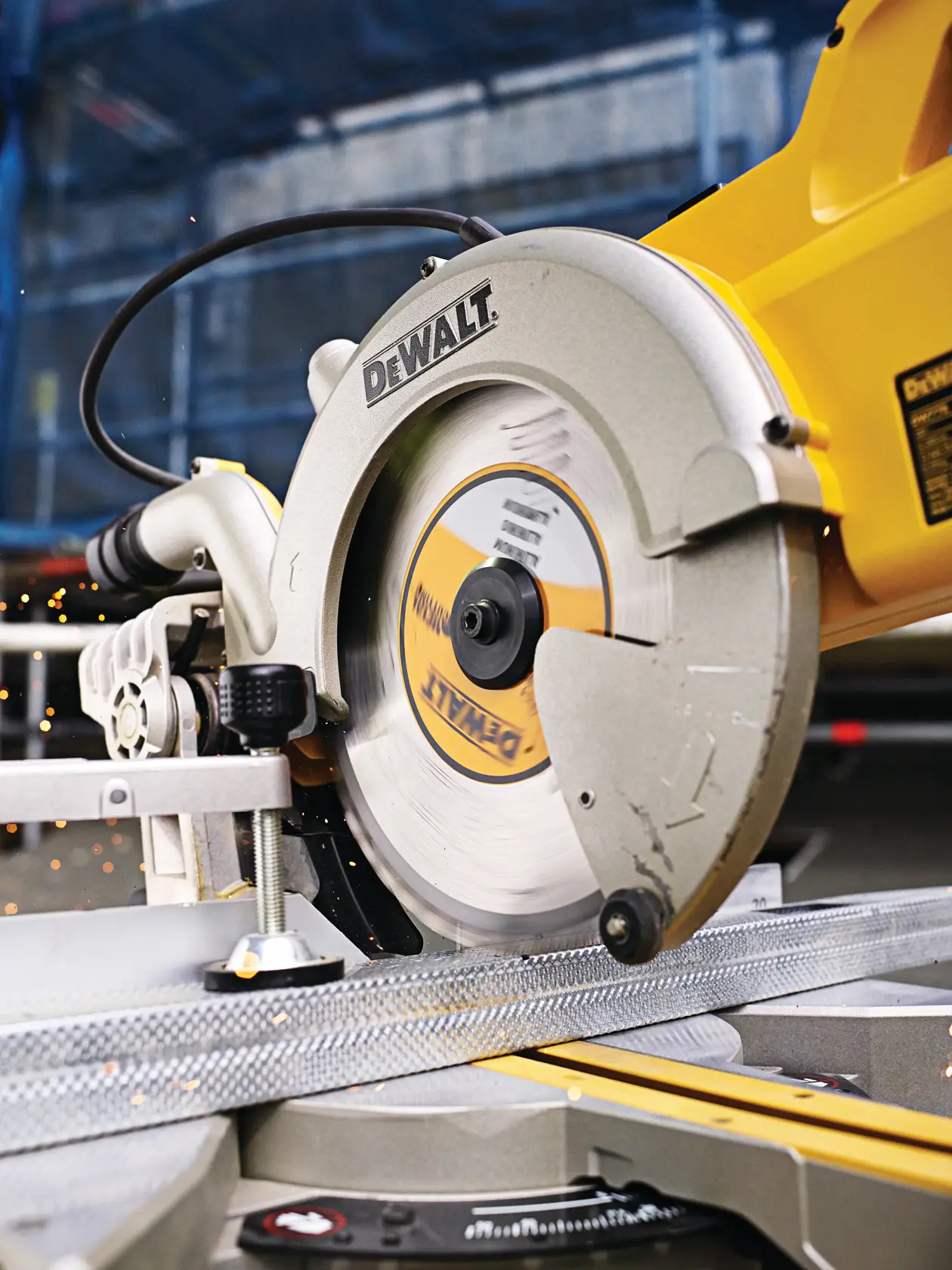 DEWALT circular saw cutting metal in workshop, close-up showing blade and sparks.