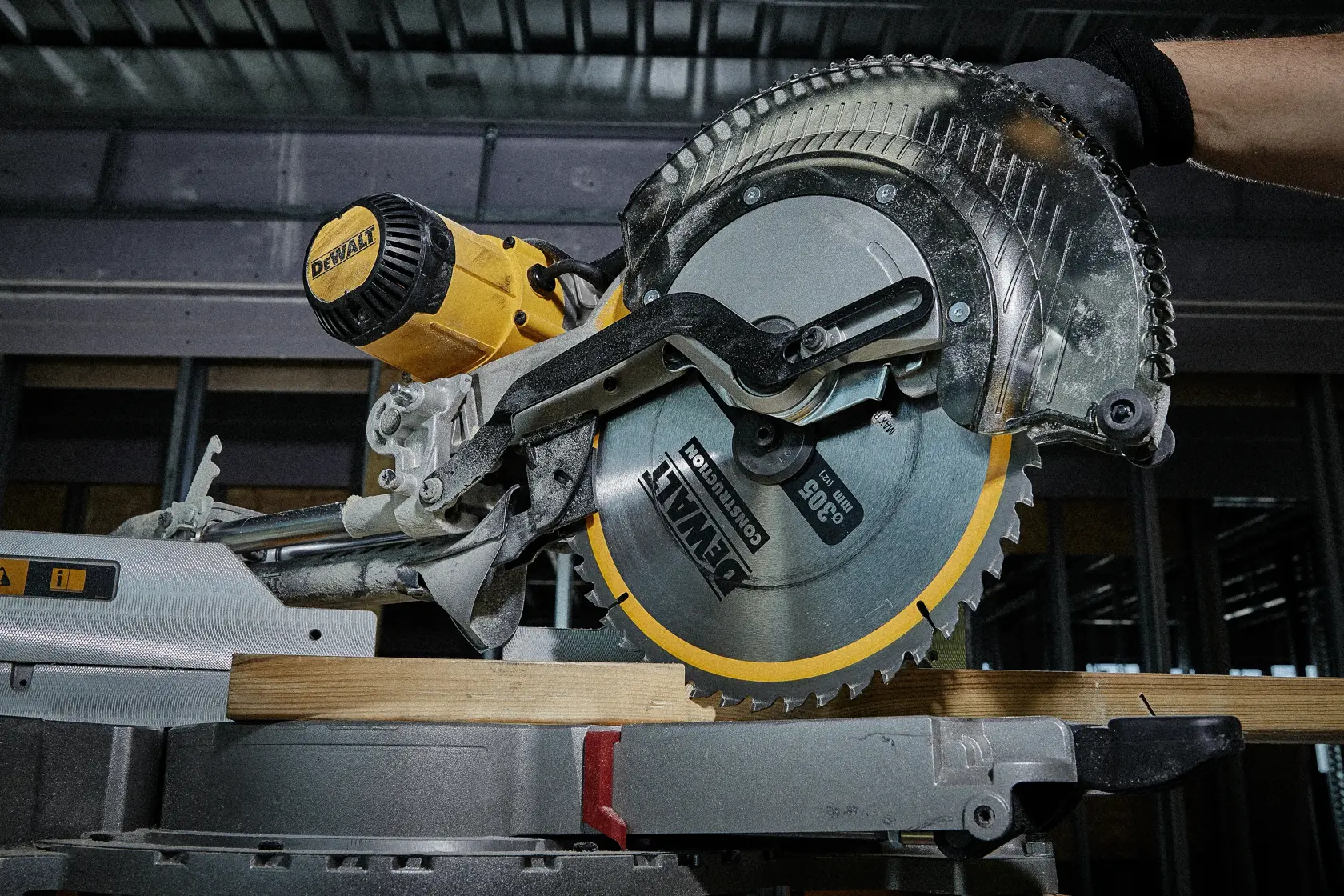 DEWALT circular saw in action cutting a piece of wood indoors, close-up of blade and motor.