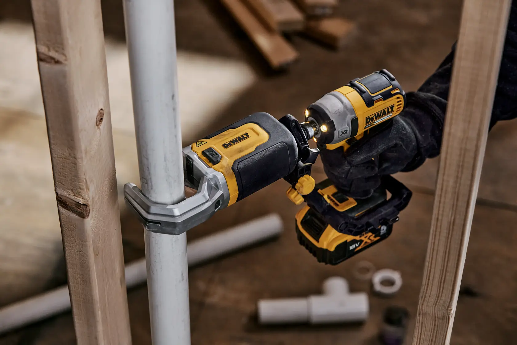 DEWALT power tool used to install or fasten a pipe, with wood and pipe fittings visible in the background.