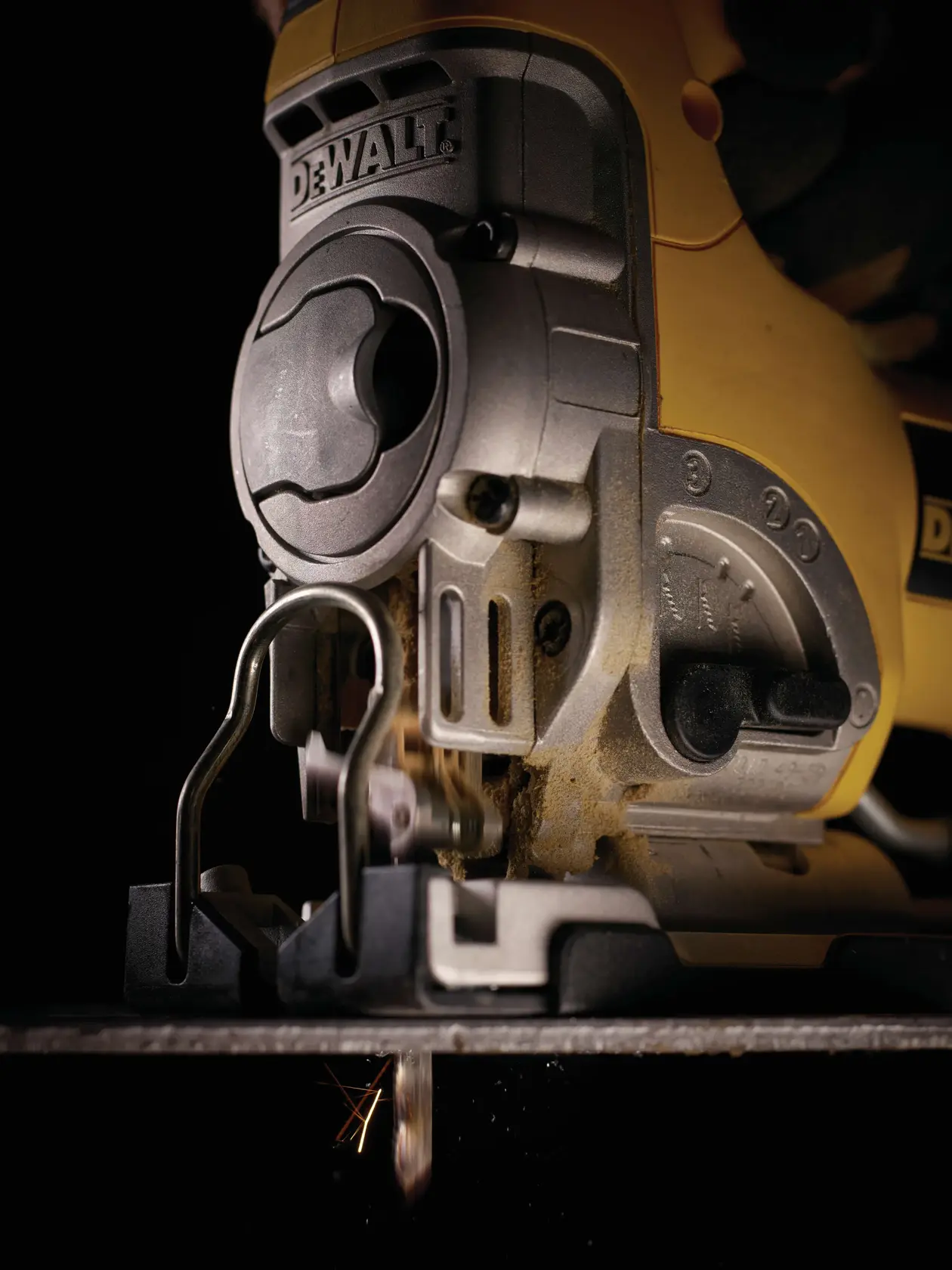 Close-up of a DEWALT jigsaw in use, cutting material. Tool details and blade are visible.