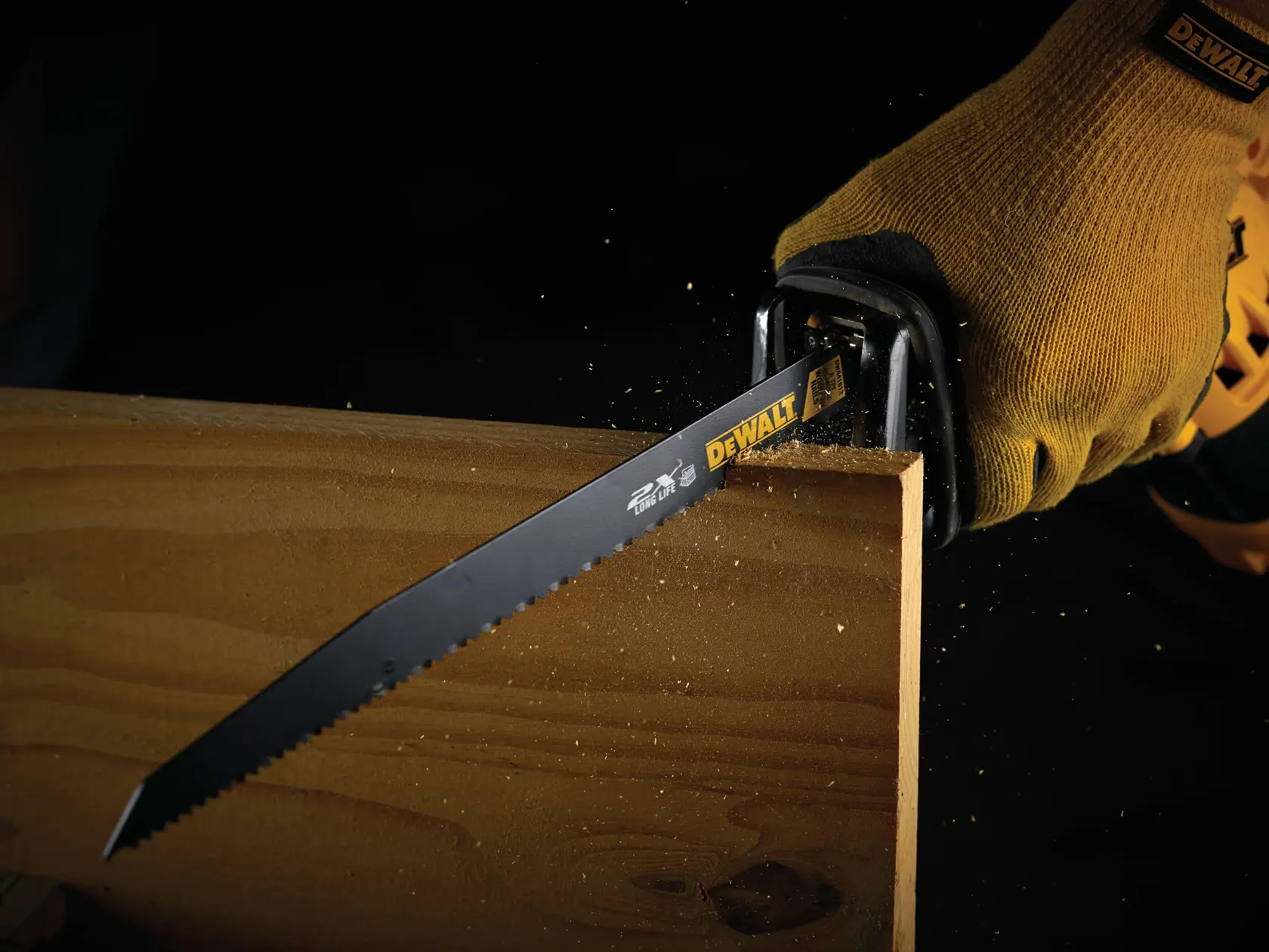 DEWALT saw blade cutting wood, used with gloved hand. Sawdust is visible during action.