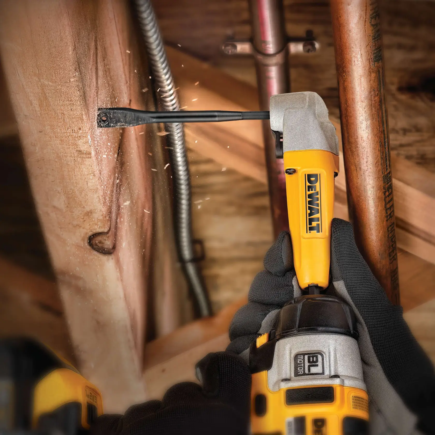 DEWALT drill with DT4770 bit drilling wood, worn by gloved hands, with sparks and copper pipes nearby.