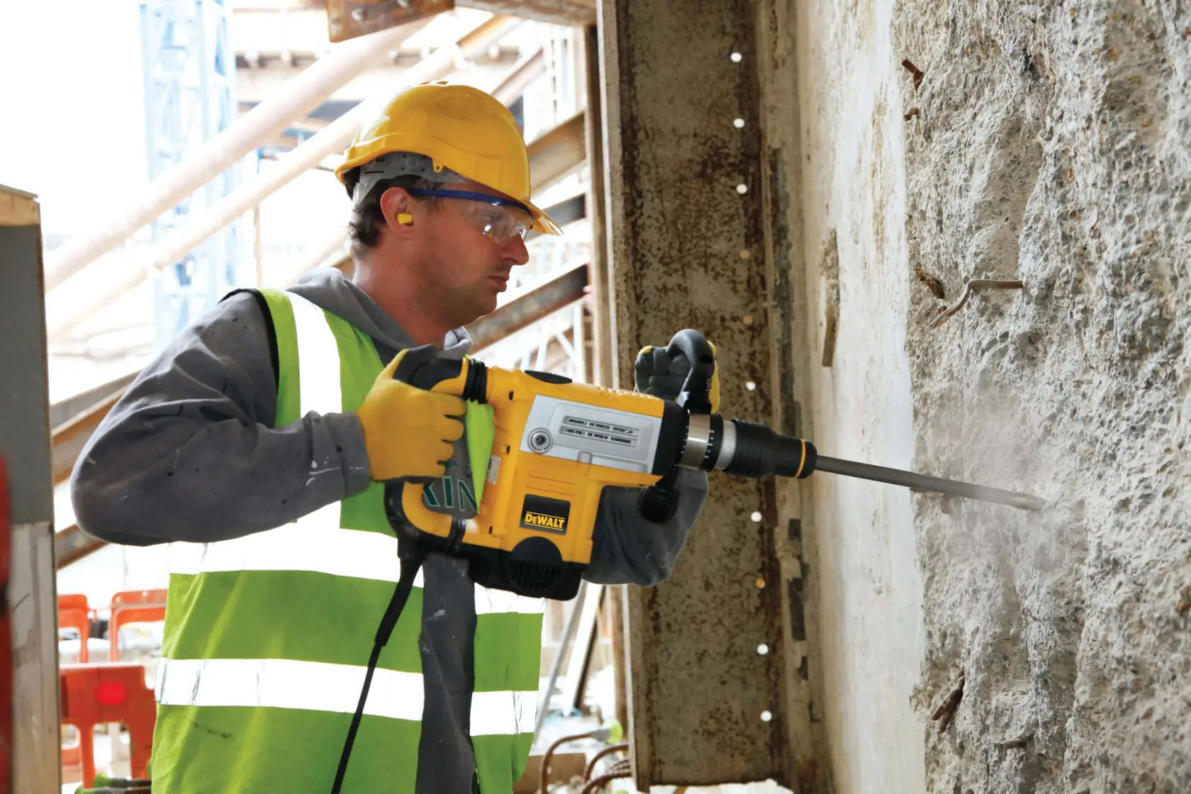 DEWALT DT8087, DT8087-QZ hammer drill used on concrete wall at construction site. Product category: Photography.