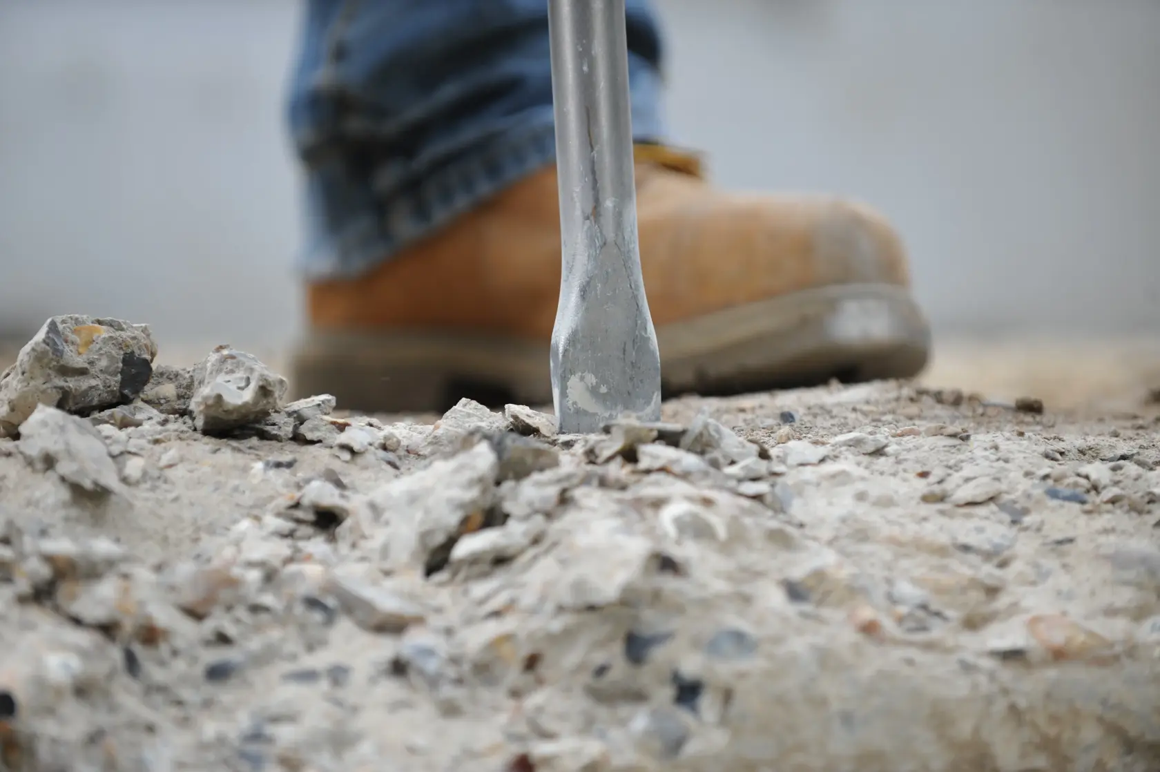 DEWALT DT8088-QZ, DT8088 chisel breaking concrete. Photography product. Worker boot visible.