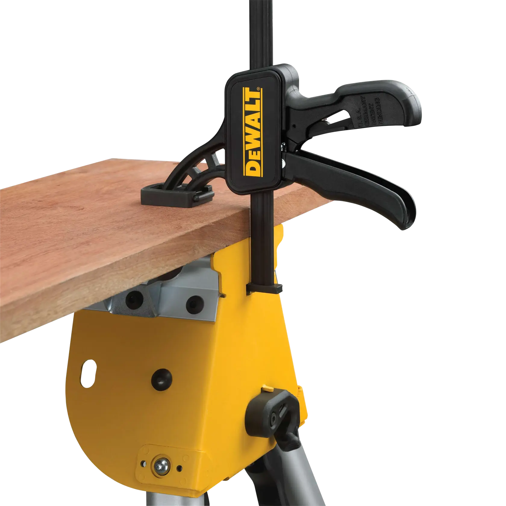 DEWALT clamp secures a wooden board to a yellow workbench for stability during cutting or assembly.